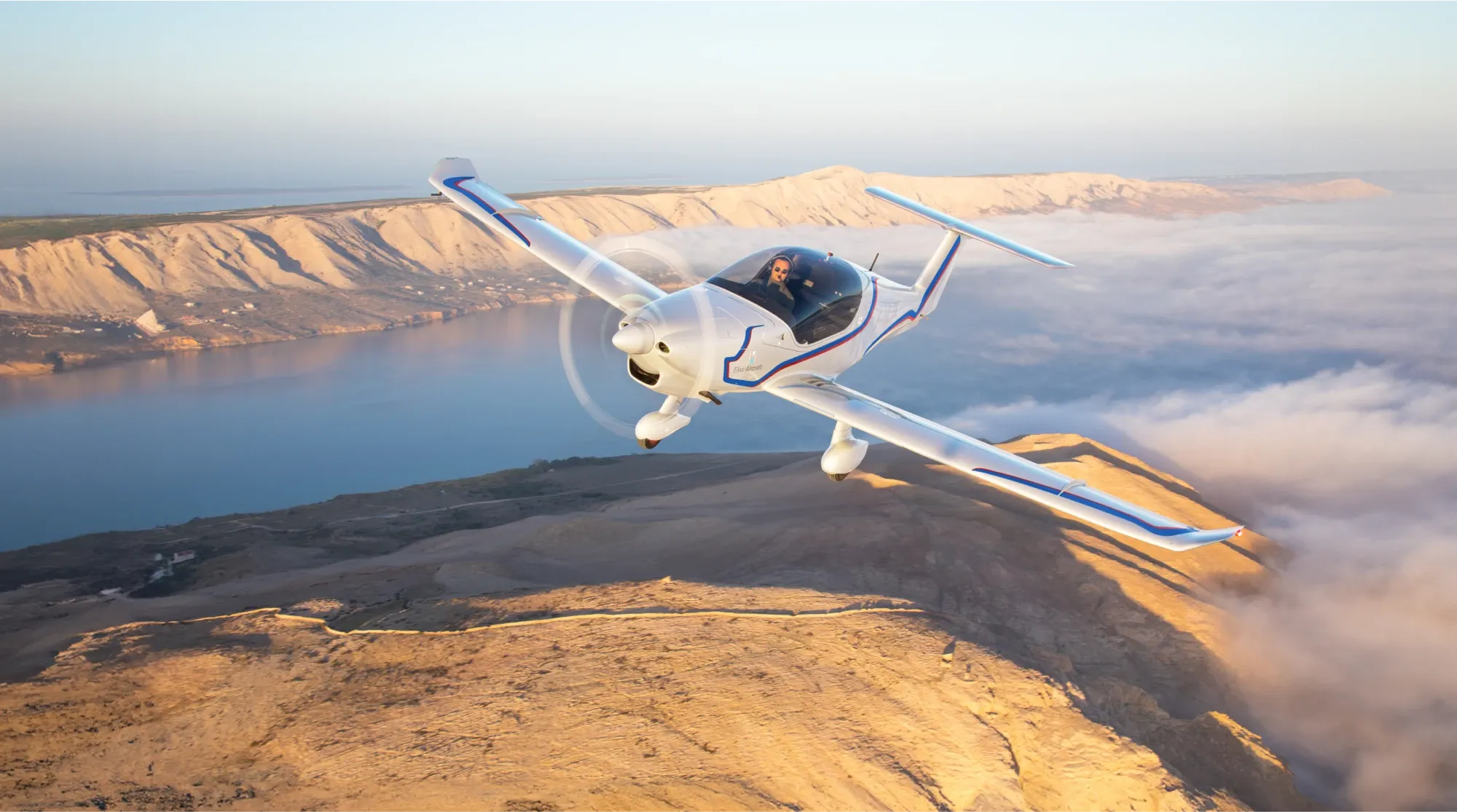 An elixir aircraft flying with pilot in the cockpit