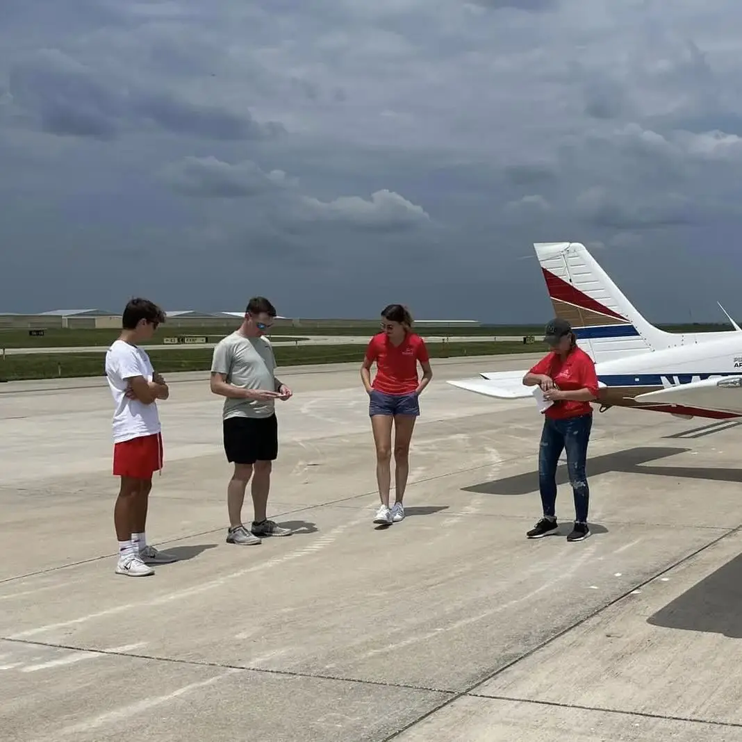 Flight school students celebrating after a successful checkride