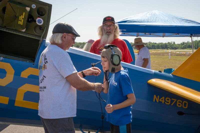 Young boy with headset and Stearman