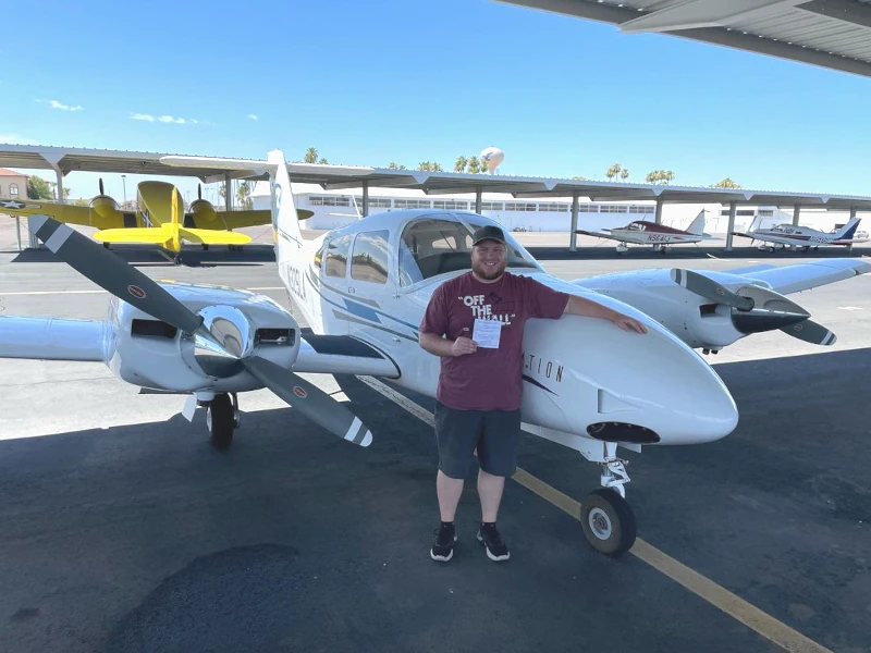 Pilot in front of a Multi Engine plane